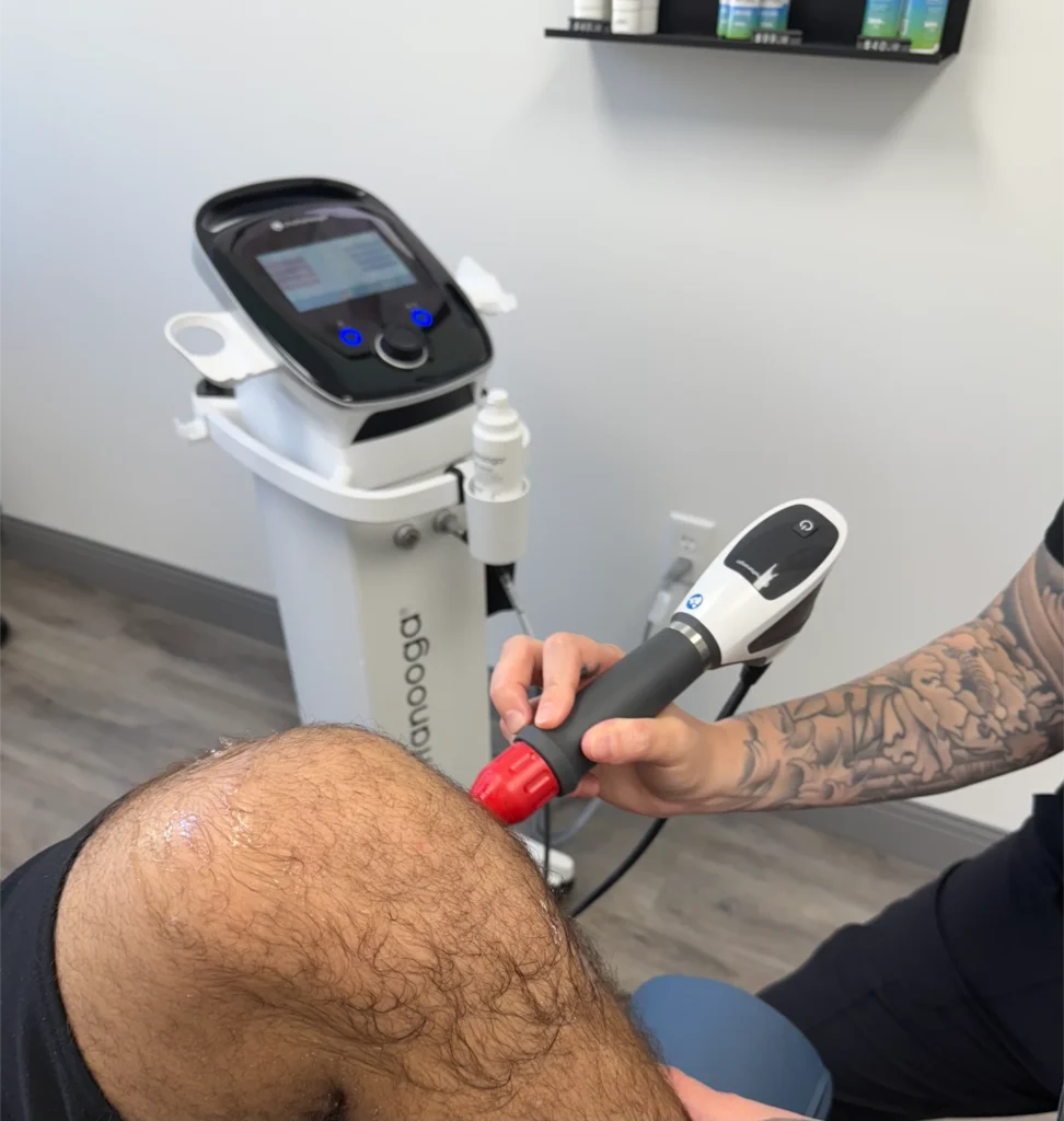 Chiropractor table | conditions treated with chiropractic care jupiter | chiropractic care for desk workers | jupiter chiropractor | Jupiter, Florida | Tequesta | Palm Beach Gardens | Jupiter Island Image of Jupiter chiropractor Alyssa Garber performing Shockwave Therapy on a client’s knee. Whether you’ve been injured or suffer from an ongoing condition, chiropractic care in Jupiter, FL, can provide natural pain relief.