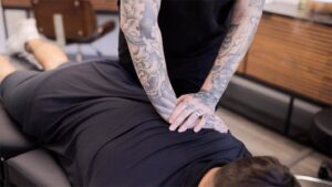 Photo of Dr. Alyssa Garber adjusting a patient. Need access to holistic wellness after business hours? Concierge chiropractic care in Jupiter, FL, ensures you have access to support and wellness when you need it.