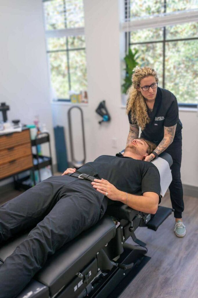 Picture of Jupiter chiropractor Alyssa Garber in a session with a patient. Wondering about how dry needling treatment works? An experienced chiropractor in Jupiter, FL, can help you decide if this therapy is right for your condition. 