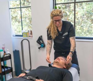 Photo of a client during a chiropractic session. If you’re looking for a new pathway toward pain relief, find out how sessions with a chiropractor for headaches & migraines in Jupiter, FL, can enhance your overall wellness.